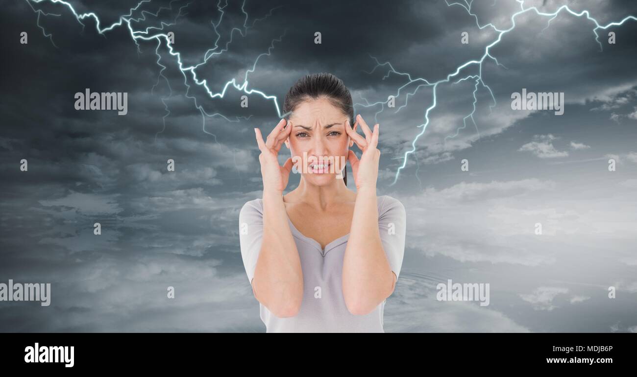 Lightning strikes and stressed woman with headache holding head Stock Photo