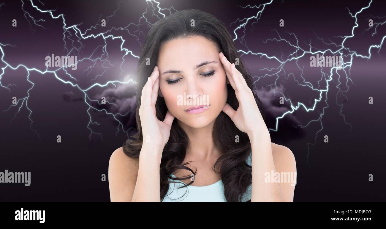Lightning strikes and stressed woman with headache holding head Stock Photo