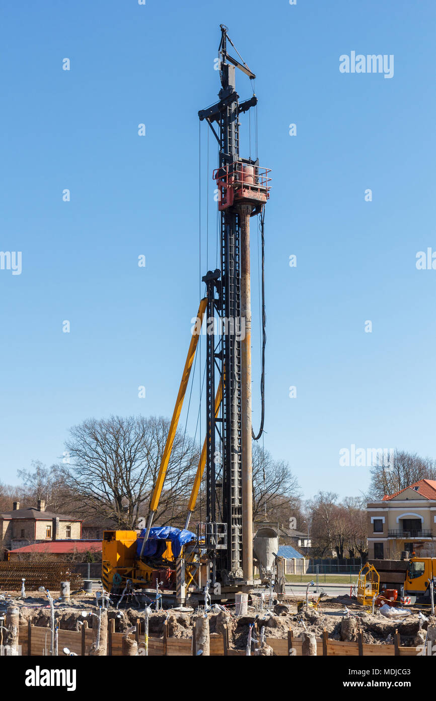 pile bore machine. A pile driver is a mechanical device used to drive piles, poles into soil to provide foundation support for buildings Stock Photo
