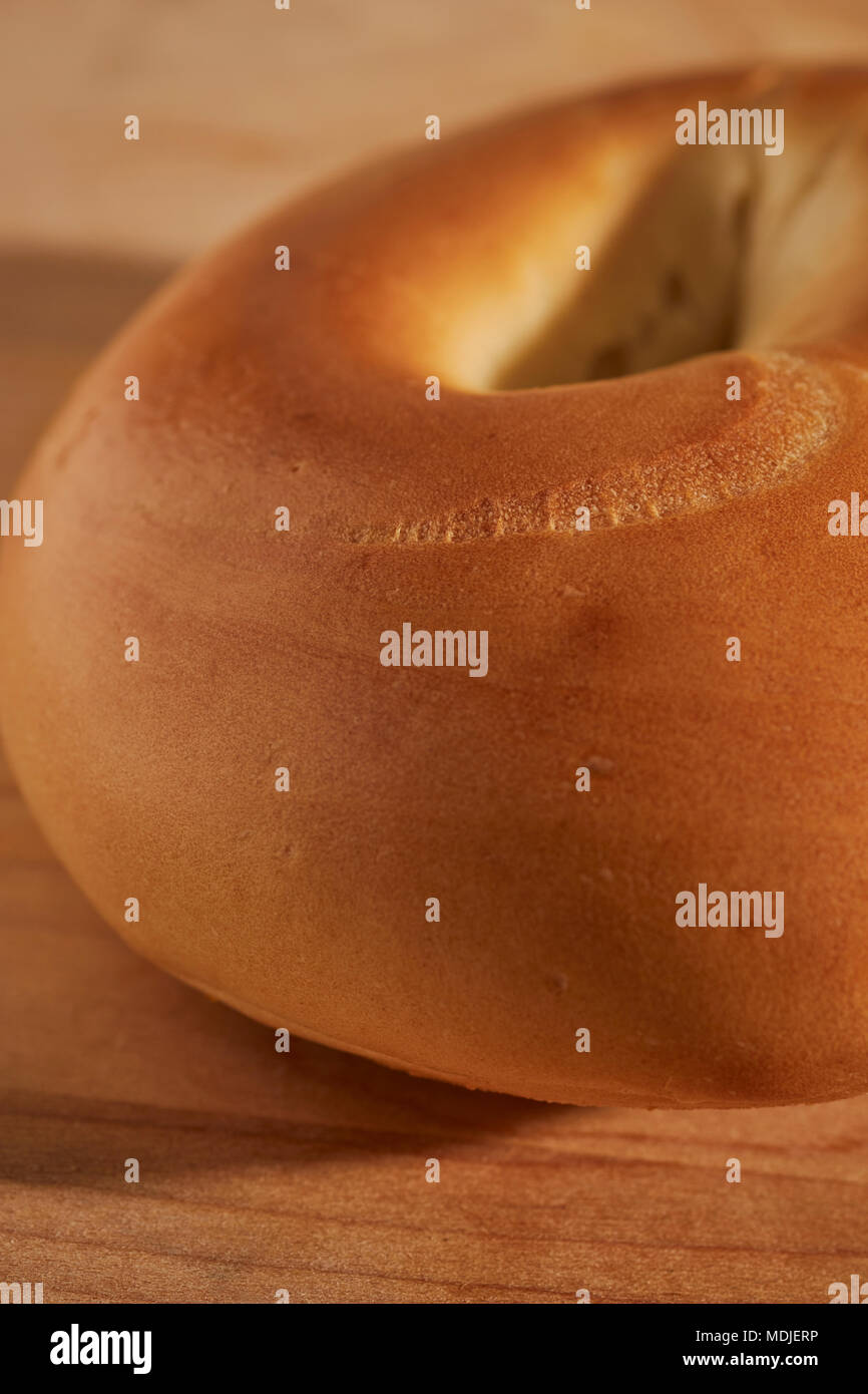 A whole, uncut plain bagel. A traidtional food from Eastern European Jewish cuisine spelled bagle in the UK Stock Photo