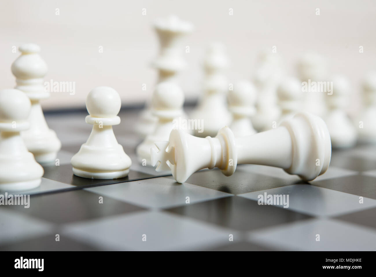 A completed chess game setup on a table with opposing chairs in a dark room  backlit by a bright window light - 3D render Stock Photo - Alamy