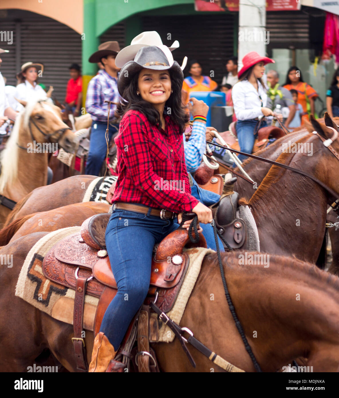 Cabalgata Riders A young woman riders her horse through the streets of David, Panama, in ...