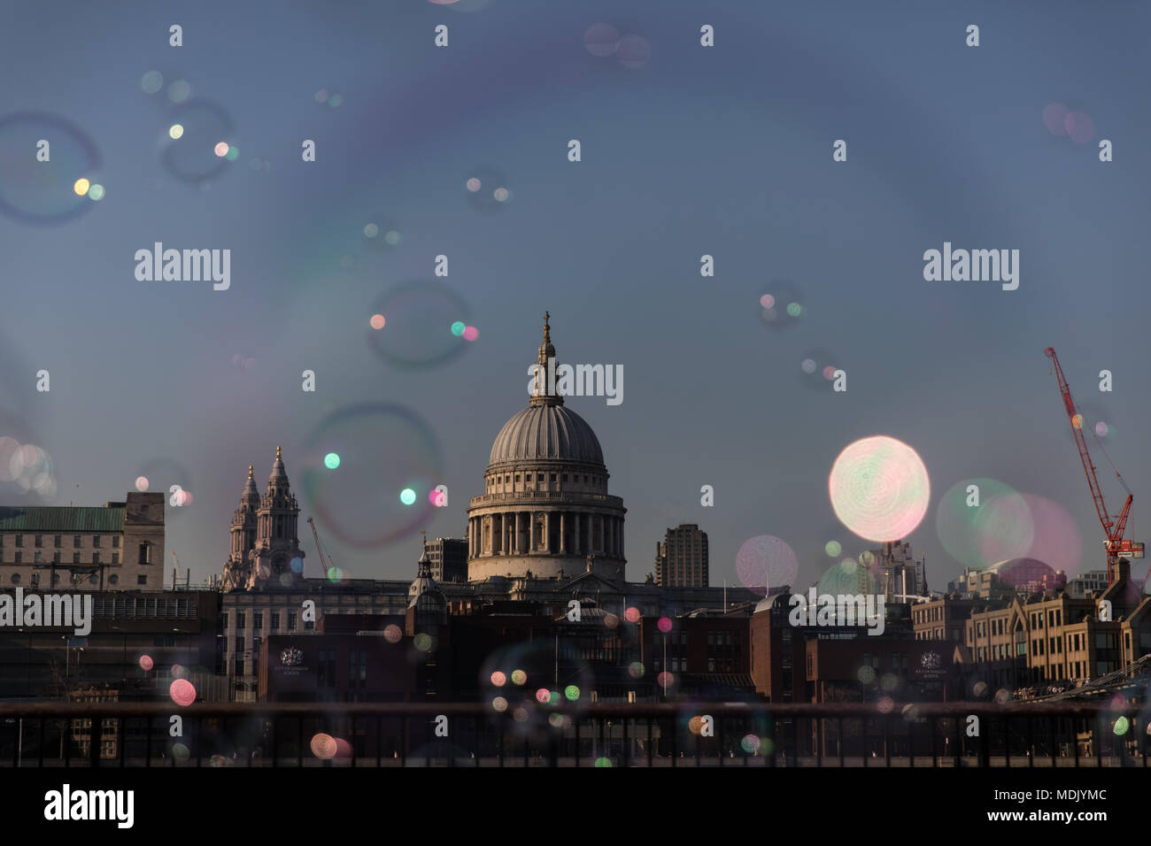 London, UK. 19th April, 2018. UK Weather: A busker makes bubbles for passers by on the southbank of the Thames during a beautiful evening in London, UK Credit: Carol Moir Stock Photo