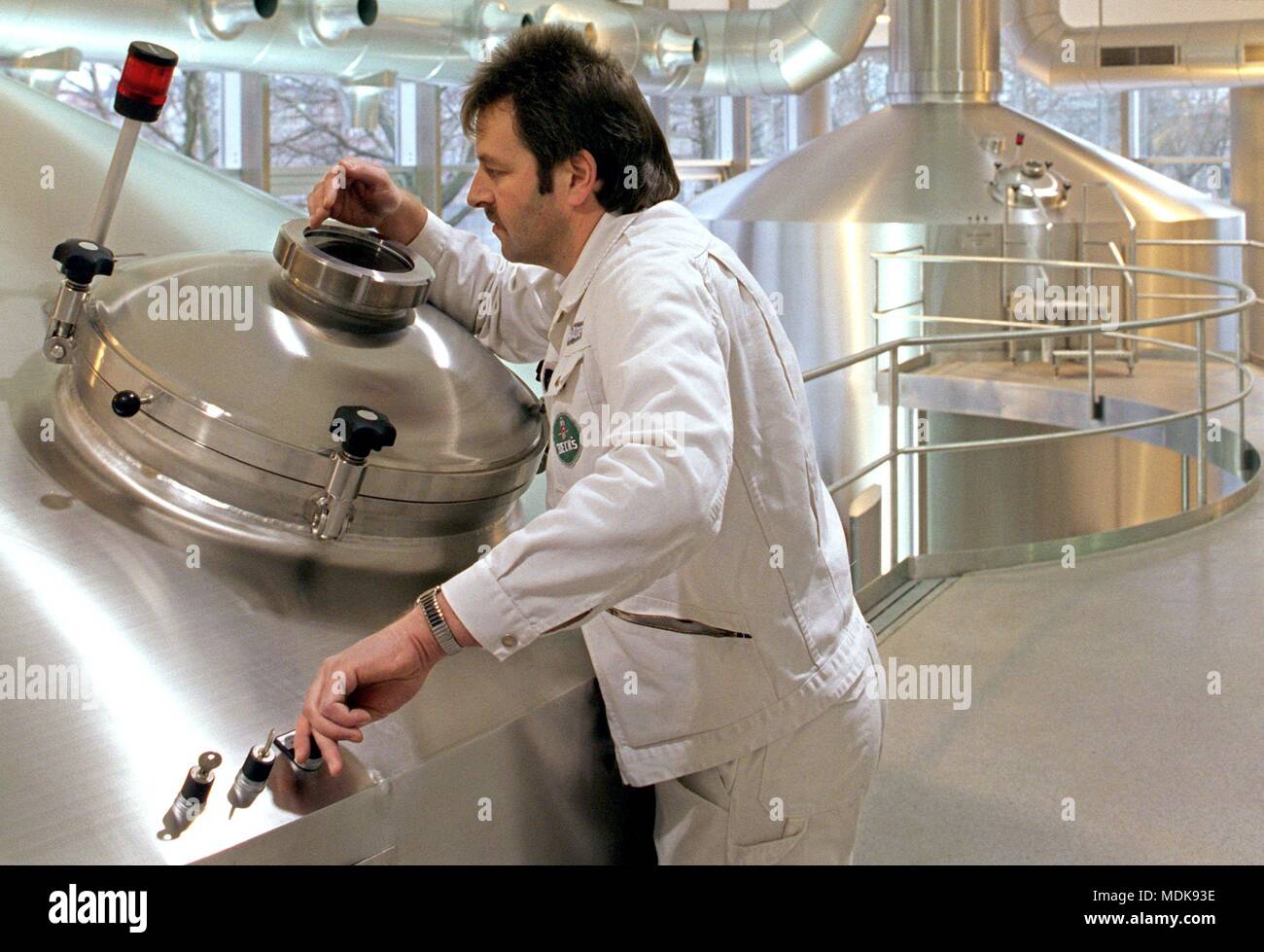 A brewing master of the Bremer Beck & Co. brewery controls the correct course of beer production in the new brewhouse of Germanys largest export brewery (archive picture from 08.12.1997). The personal concern for production in the computer-controlled high-tech brewhouse ensures quality and consistency in the brewing process. In keeping with its 125th anniversary (June 27, 1998), Beck has increased beer sales by just over two percent. By the end of the financial year 1997/98 on June 30, then the limit of five million hectoliters would be exceeded, said managing director Gotz-Michael Mullerwith. Stock Photo