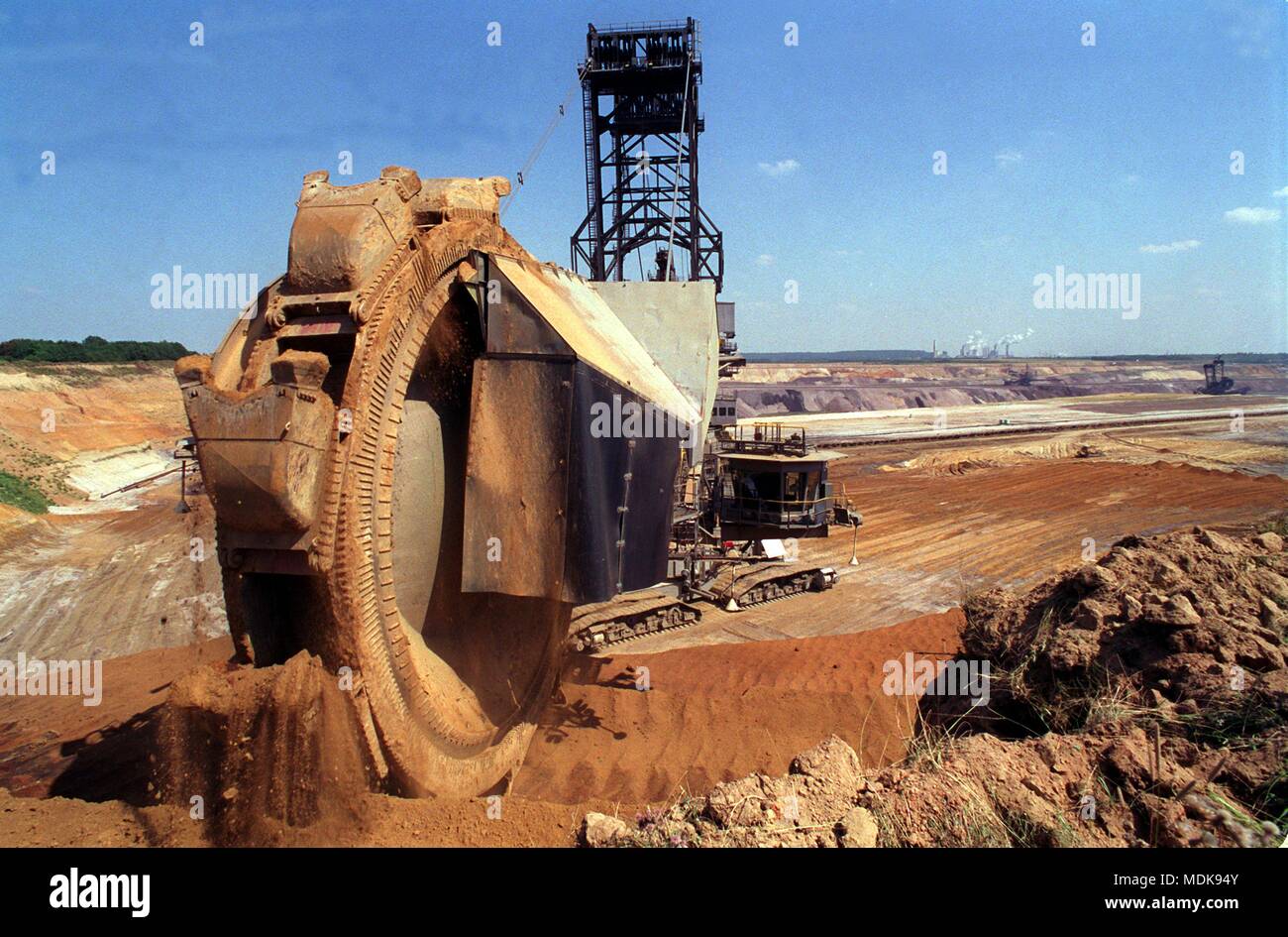 A giant excavator works through the mining area Garzweiler I, taken on 29 July 1999. In the city triangle Koln, Aachen and Monchengladbach stores the largest closed brown coal deposits in Europe. For the mining field Garzweiler (until 1987 open-pit mine Frimmersdorf) six villages with about 2800 people were resettled since 1956. | usage worldwide Stock Photo