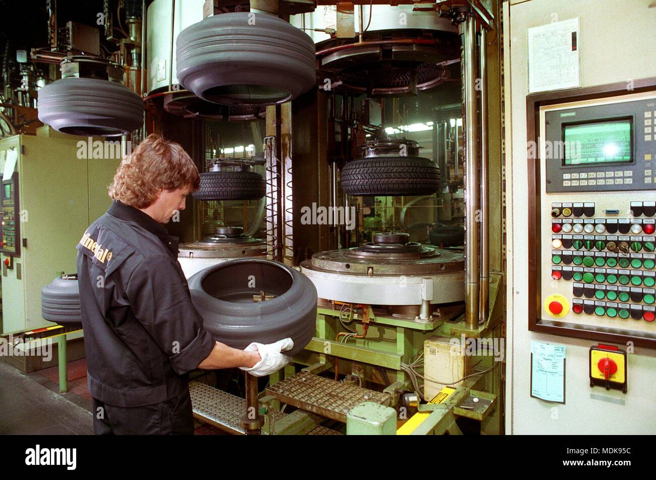 A worker at the heating press for the vulcanization of truck tires. Taken on June 8, 1994. | usage worldwide Stock Photo