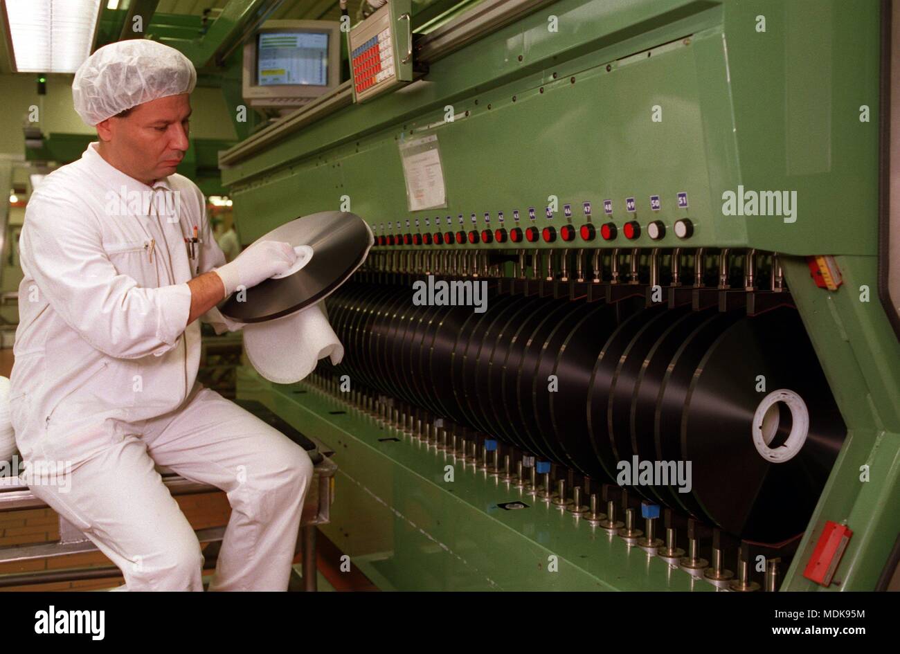 Willstatt/Baden-Wurttemberg, 18.1.96: A worker working on a cutting machine for video magnetic tape at the BASF Magnetics works inspects the winding mirror of a video magnetic tape blank roll. After three years in the loss zone, the manufacturer of audio and video cassettes as well as magnetic tape for the music and computer industry presented for the first time a balanced result in 1994, the group turnover was 1.6 billion marks. The company sells around 270 million audio and video cassettes per year, making dawith one of the world's leading manufacturers in this field. | usage worldwide Stock Photo