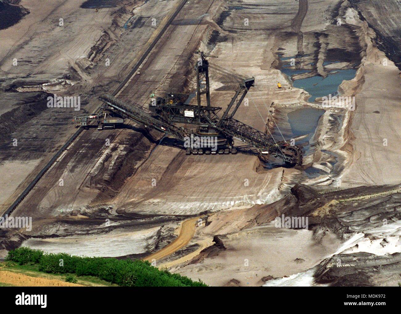A giant excavator works its way through the mining area Garzweiler I (taken 6.6.1996). In the city triangle Koln, Aachen and Monchengladbach the largest closed brown coal deposit of Europe is stored. For the mining field Garzweiler (until 1987 open-pit mine Frimmersdorf) six villages with about 2800 people were resettled since 1956. | usage worldwide Stock Photo
