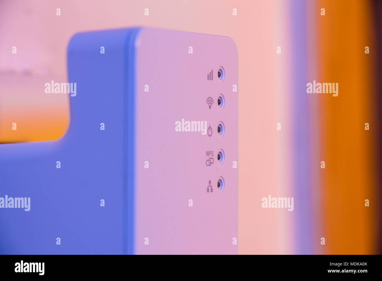 Closeup on WiFi repeater signal connection status led lights. The device is in electrical socket