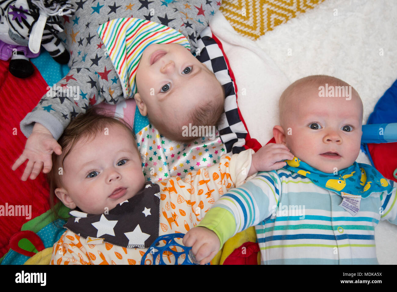 Babies lying on playmat Stock Photo