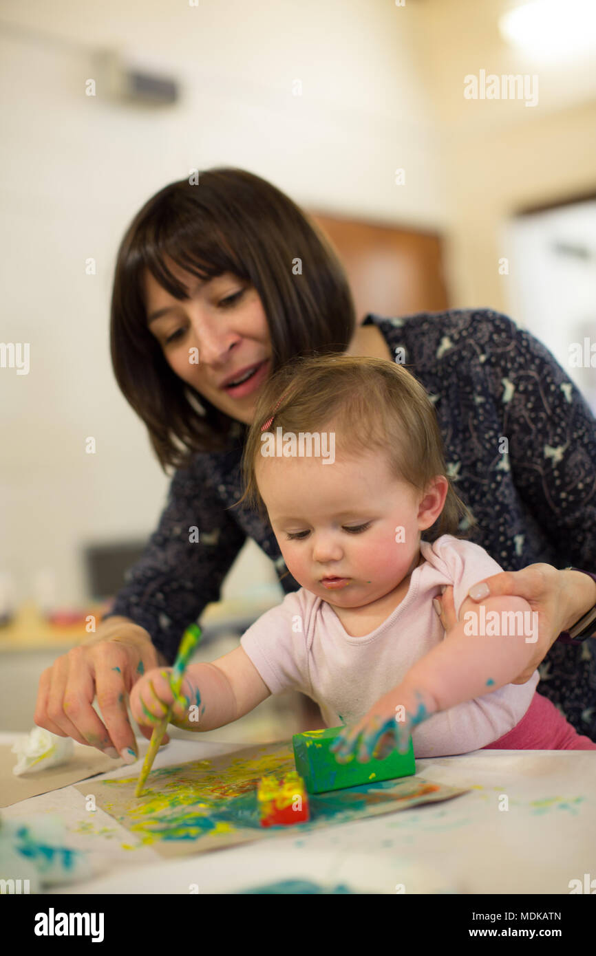Mum and 6 month old baby painting Stock Photo