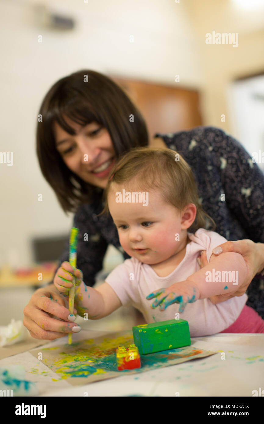 Mum and 6 month old baby painting Stock Photo