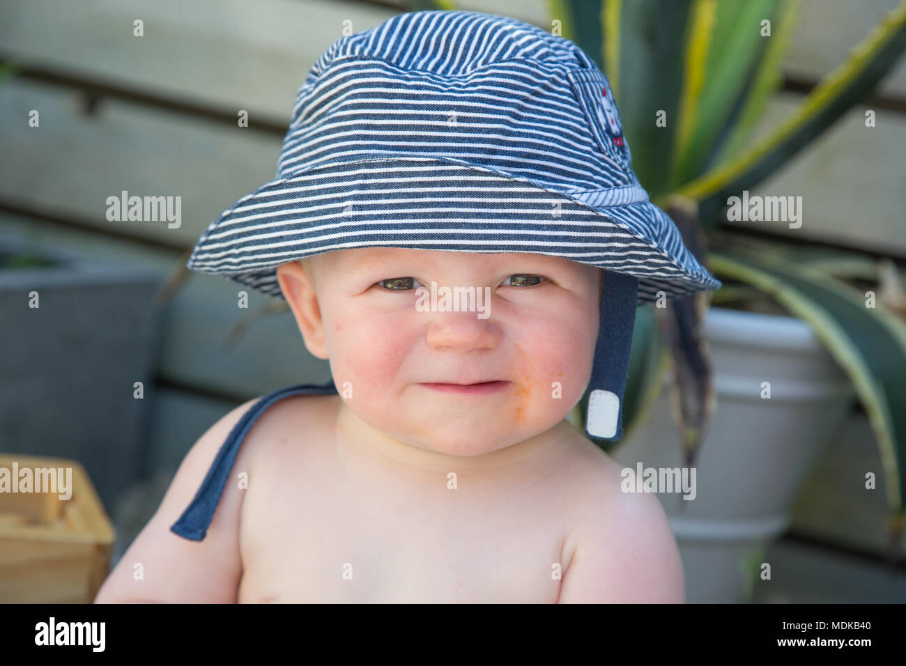 Baby wearing a sun hat Stock Photo Alamy
