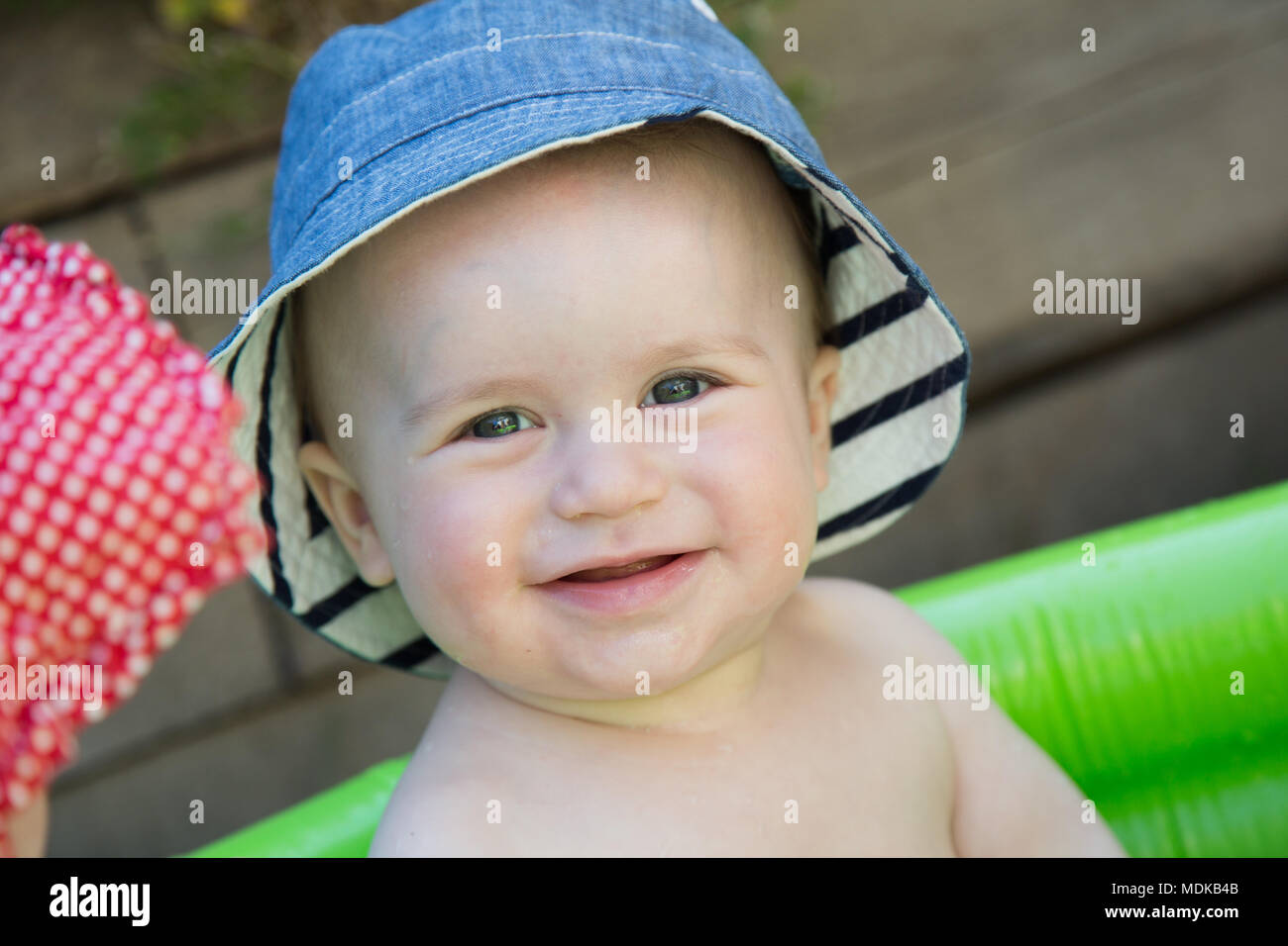 Baby wearing a sun hat Stock Photo Alamy