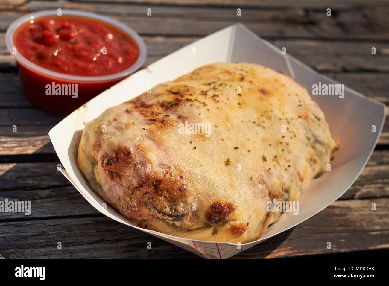 A stromboli, a typical Italian American stuffed pastry. Sometimes called a 'boli.' Stock Photo
