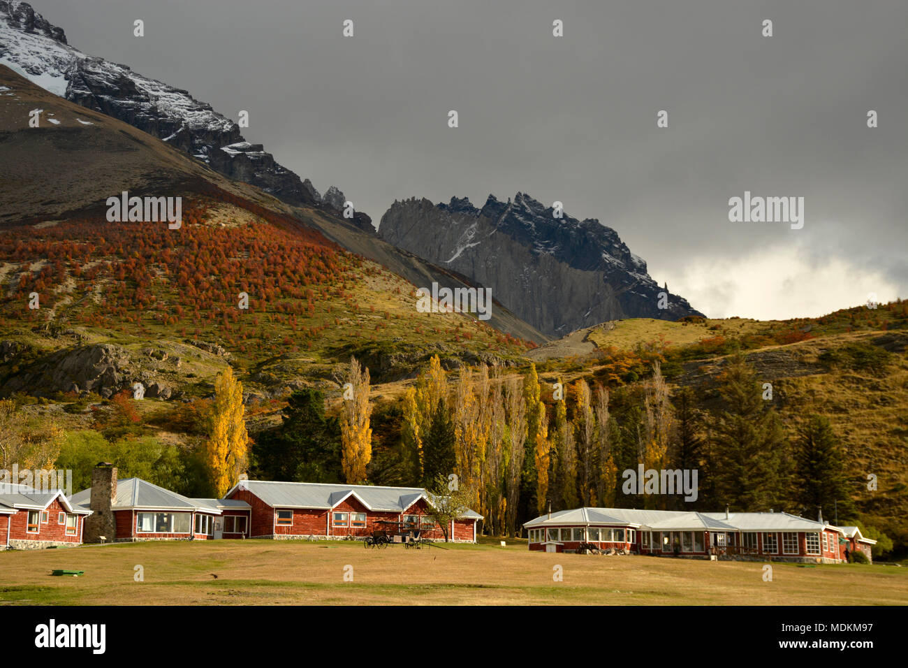 Ranch house and stables at base of hill in with hi-res stock ...
