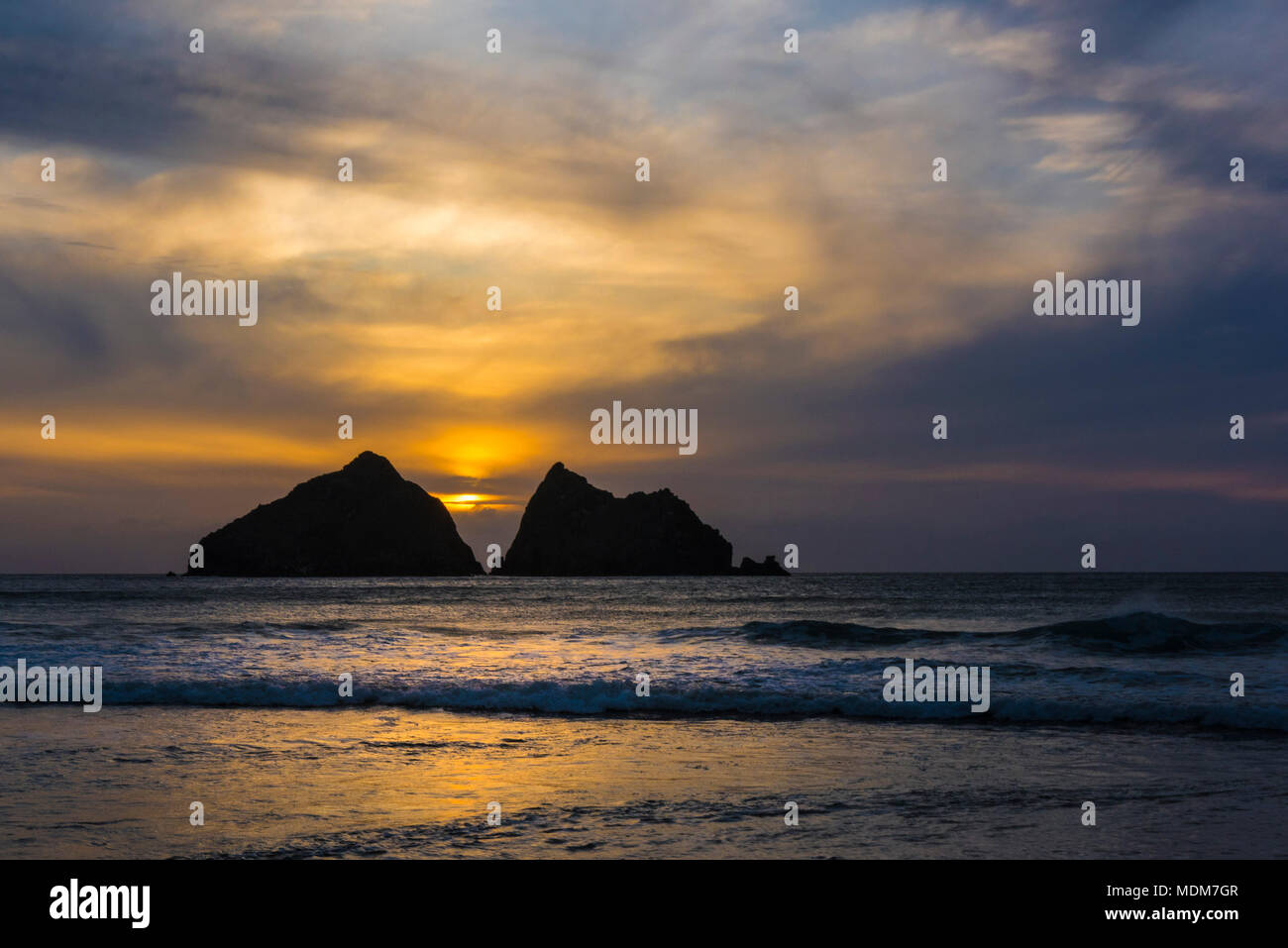 A spectacular sunset over the iconic Carters Rocks at Holywell Bay in Cornwall. Stock Photo