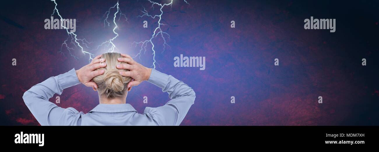 Lightning strikes and stressed woman with headache holding head Stock Photo