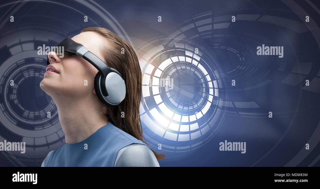 Woman with virtual reality headset and Glowing circle technology interface Stock Photo