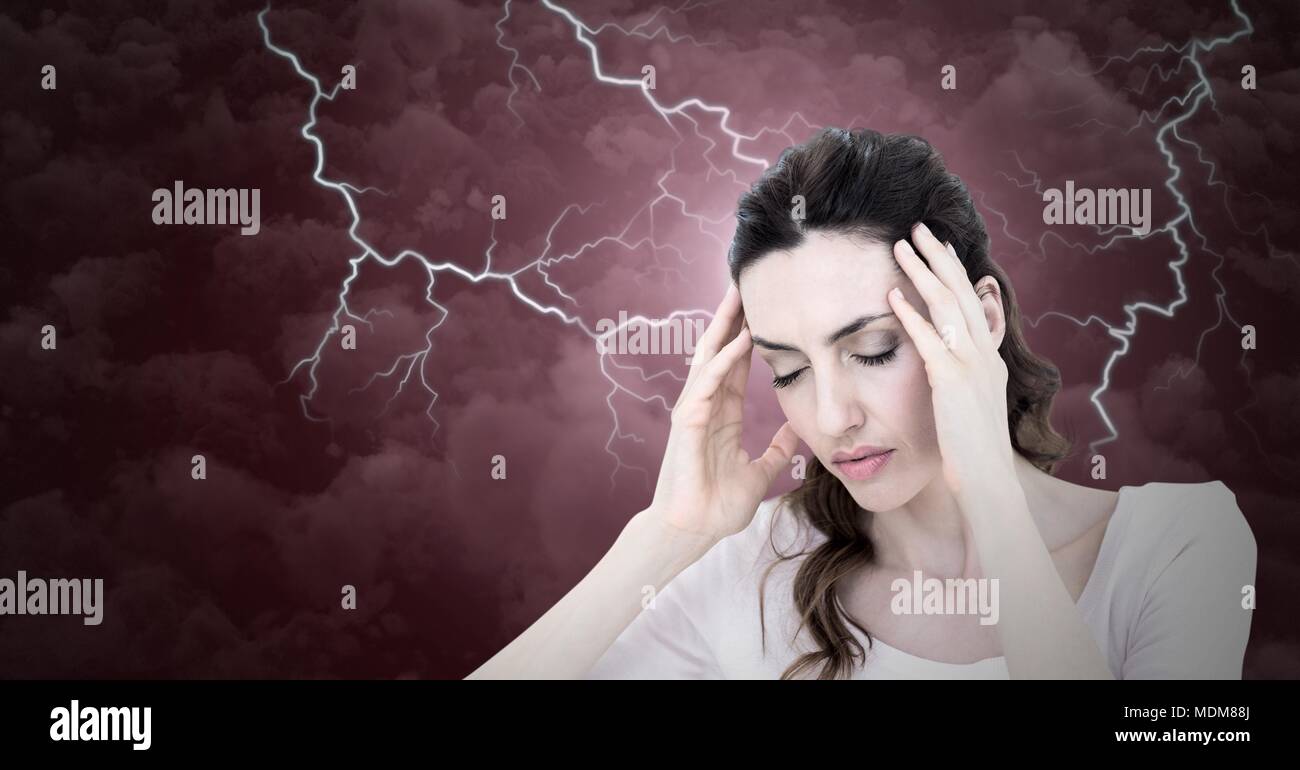 Lightning strikes and stressed woman with headache holding head Stock Photo