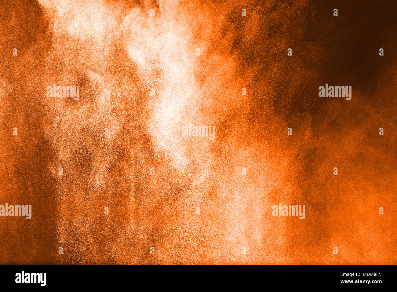Red powder explosion on black background. Red dust splash on dark background. Stock Photo