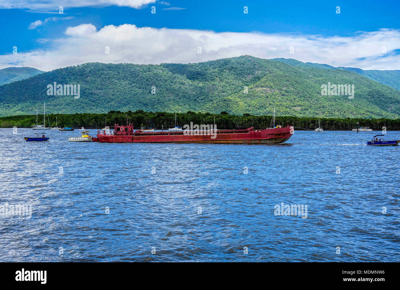Australia Cairns Harbor with a long barge coming in to port Stock Photo