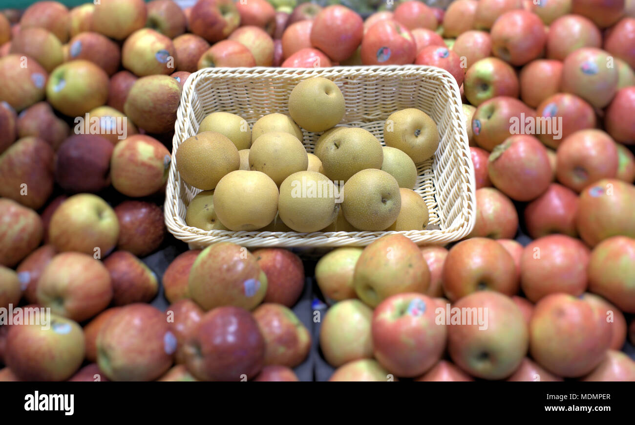 Asian pear in basket sold at market. Selective focus on pears of Asian