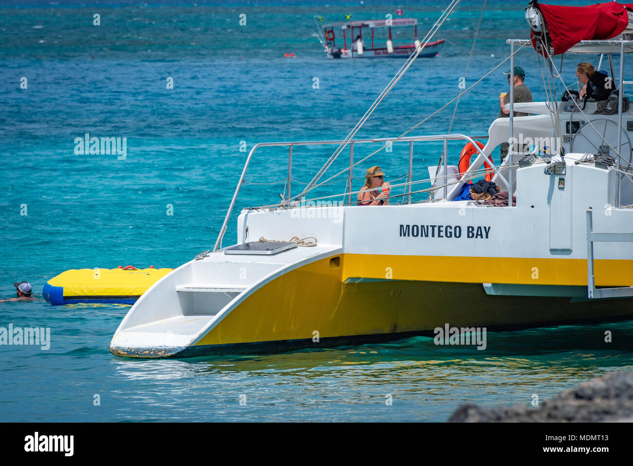 Montego Bay, Jamaica - March 20 2018: Tourists on a catamaran in Montego Bay. Stock Photo
