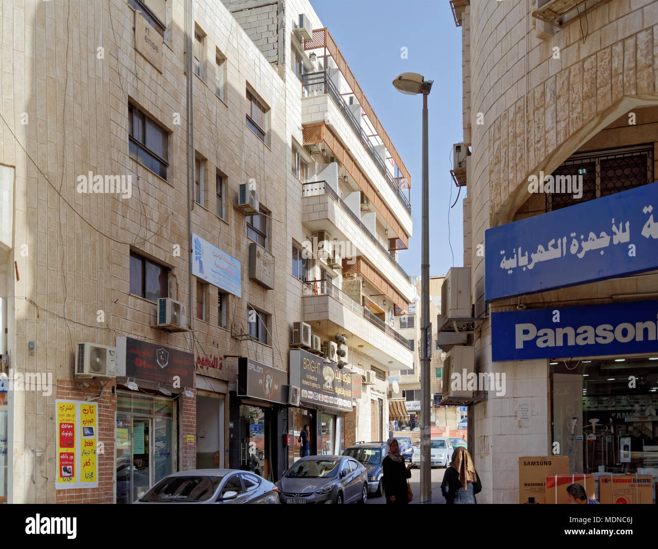 Aqaba, Jordan, March 7, 2018: Narrow shopping street with shops and apartments in a suburb of Aqaba at the Red Sea Stock Photo
