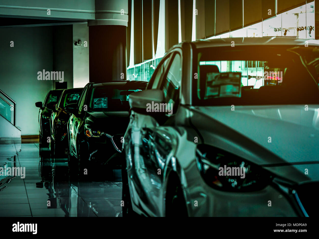 Closeup new luxury compact car parked in modern showroom for sale. Car