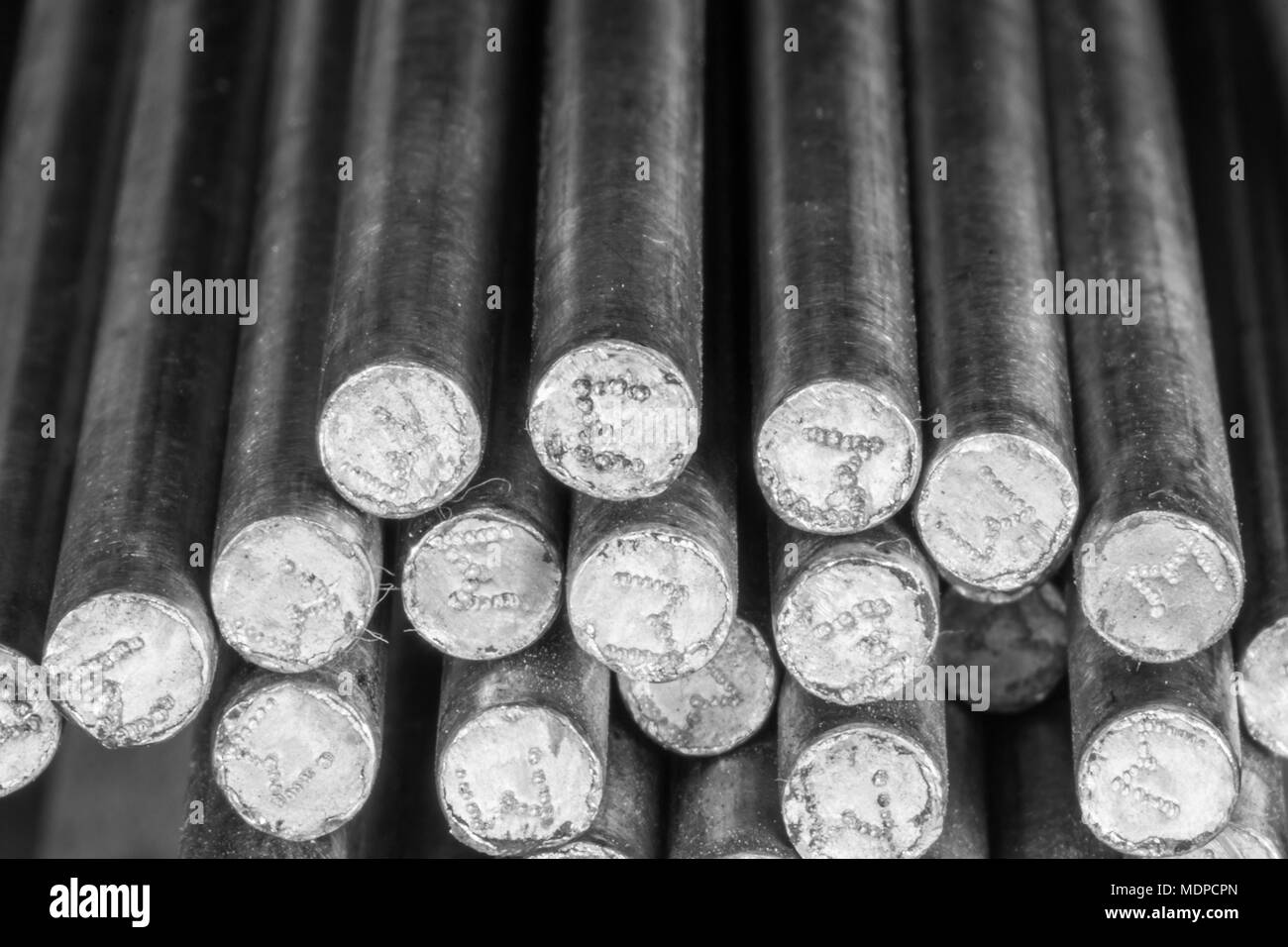 Stack of round steel bar - iron metal rail lines material for industry construction. Stock Photo