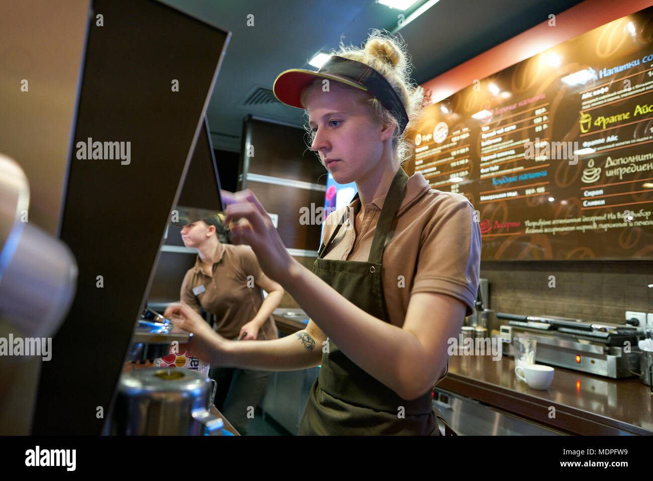 Mccafe Worker SAINT PETERSBURG, RUSSIA - CIRCA OCTOBER, 2017: worker at a McCafe ...