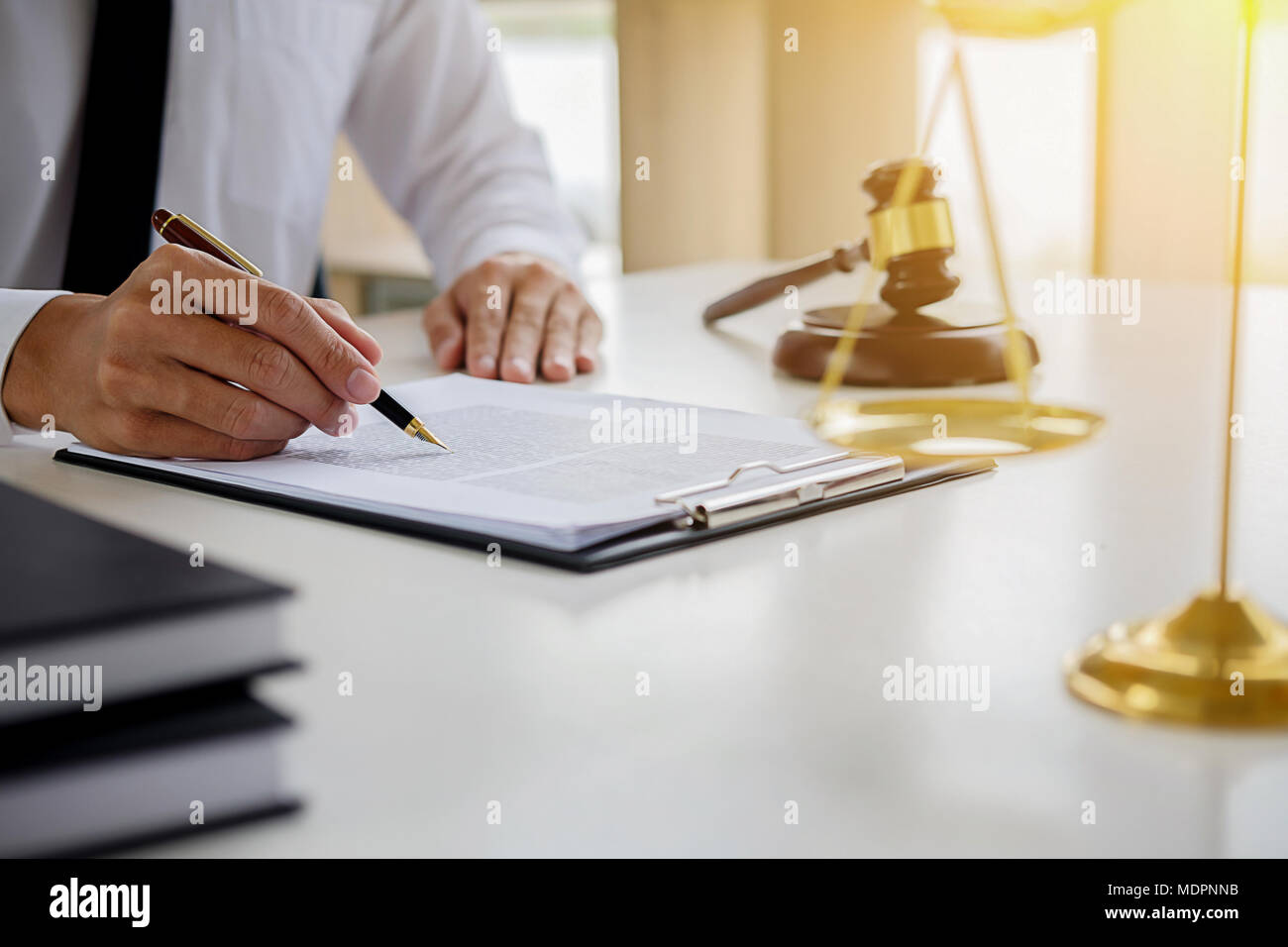 Justice and Law concept. Legal counsel presents to the client a signed contract with gavel and legal law or legal having team meeting at law firm Stock Photo