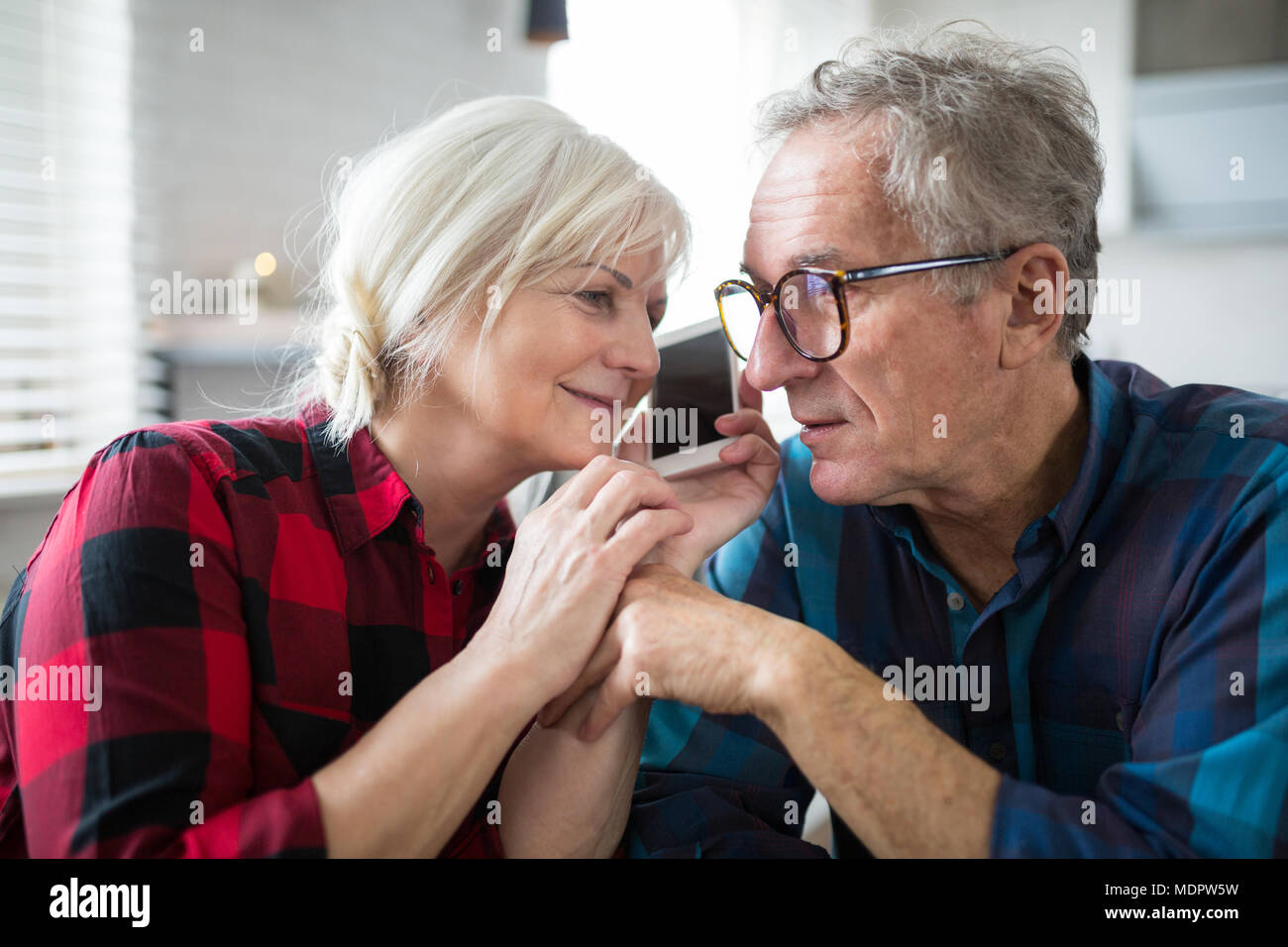 Portrait of senior marriage having phone conversation together Stock Photo