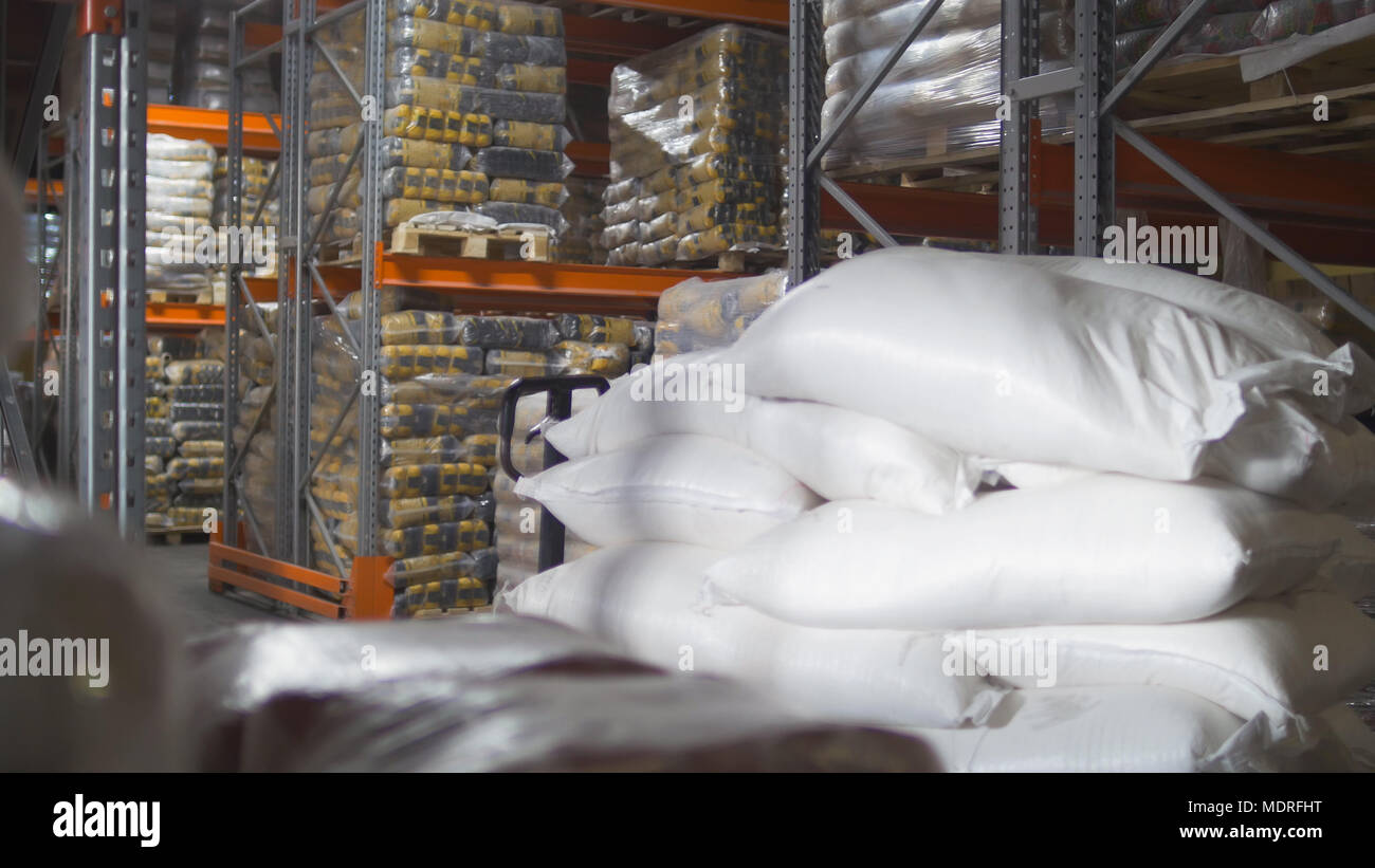 A bags with sugar inside a large industrial warehouse Stock Photo - Alamy