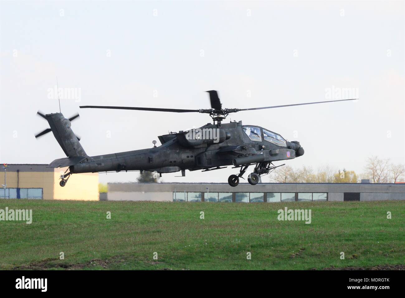 A U.S. Army AH-64 Apache helicopter from 1st Battalion, 3rd Aviation Regiment (Attack Reconnaissance) conducts a traffic pattern training flight April 17, 2018, at Katterbach Army Airfield in Ansbach, Bavaria, Germany. During traffic pattern training flights, pilots perform multiple important maneuvers and tasks, including taking off, making coordinated turns, managing airspeed and landing. (U.S. Army photo by Charles Rosemond) Stock Photo