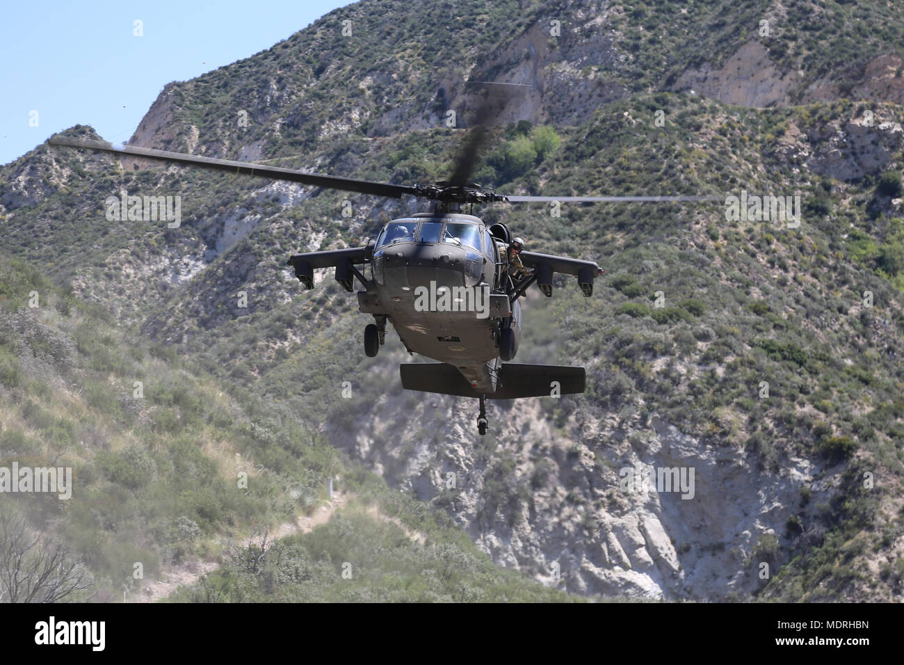 U.S. Army Black Hawk prepares to land at Big Tujunga Dam Ca., Apr. 18, 2018. The Prominent Hunt 18-1 exercise brings in federal, state, and local agencies to confirm the oncoming 20th CBRNE Ground Collection Team as well as enable other Task Force members to conduct collective and individual training as part of the National Technical Nuclear Forensics (NTNF) Ground Collection Task Force (GCTF). (U.S. Army photo by Pfc. Julie Driver) Stock Photo