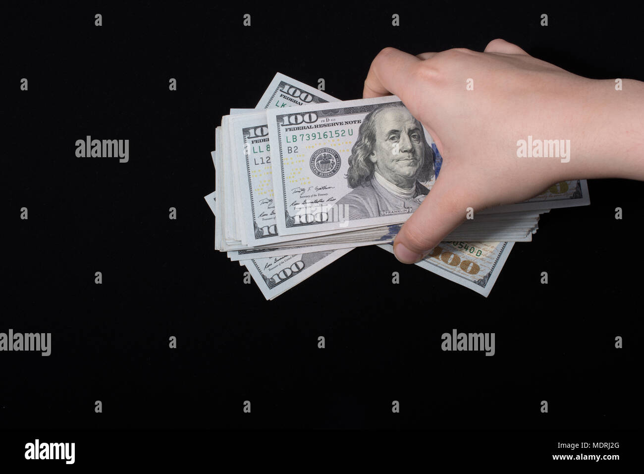 Hand holding American dollar banknotes isolated on white background ...