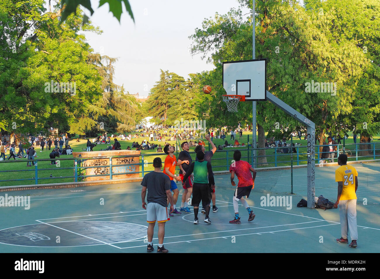 Bologna, Italy June 2017 Teenagers playing basketball at City park