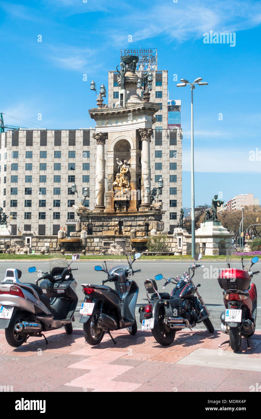 Motorbikes parked in front of the fountain at the PLaca d'Espanya in the Sants-Montjuic district of Barcelona. Stock Photo