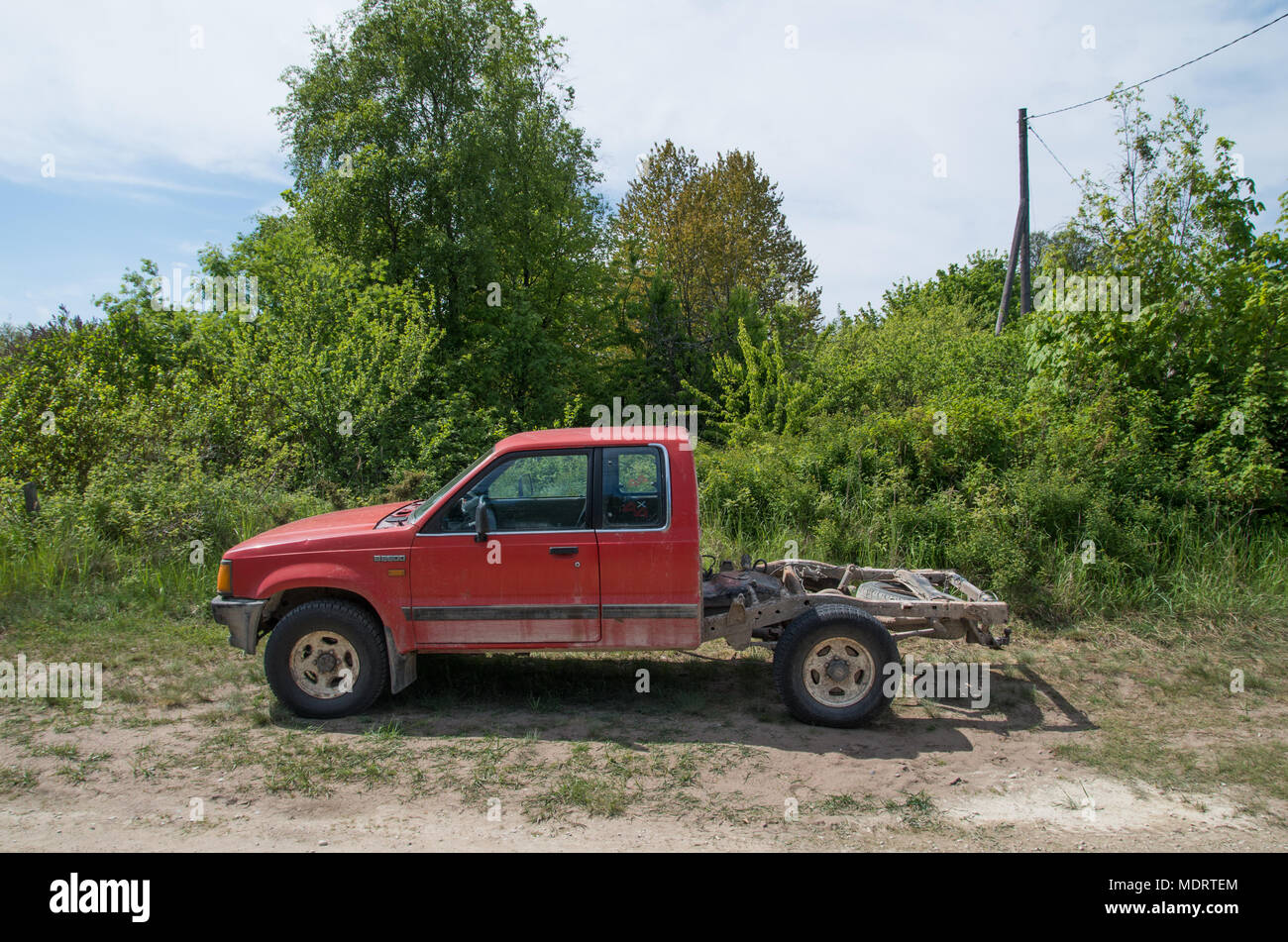 An old red pick-up truck with the boot taken off. Estonian island of Prangli. Stock Photo