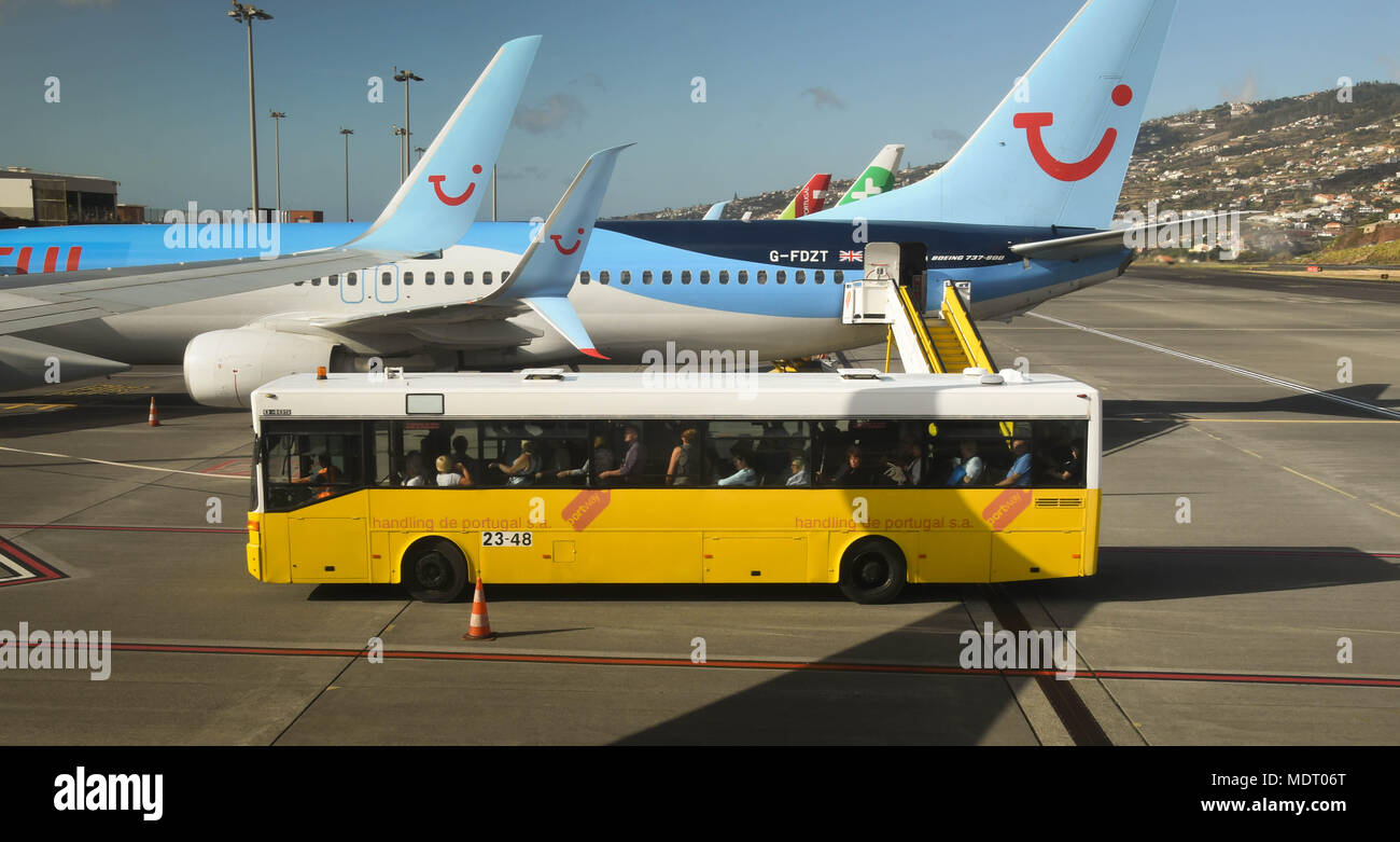 A bus bringing passengers from the terminal to board their plane Stock