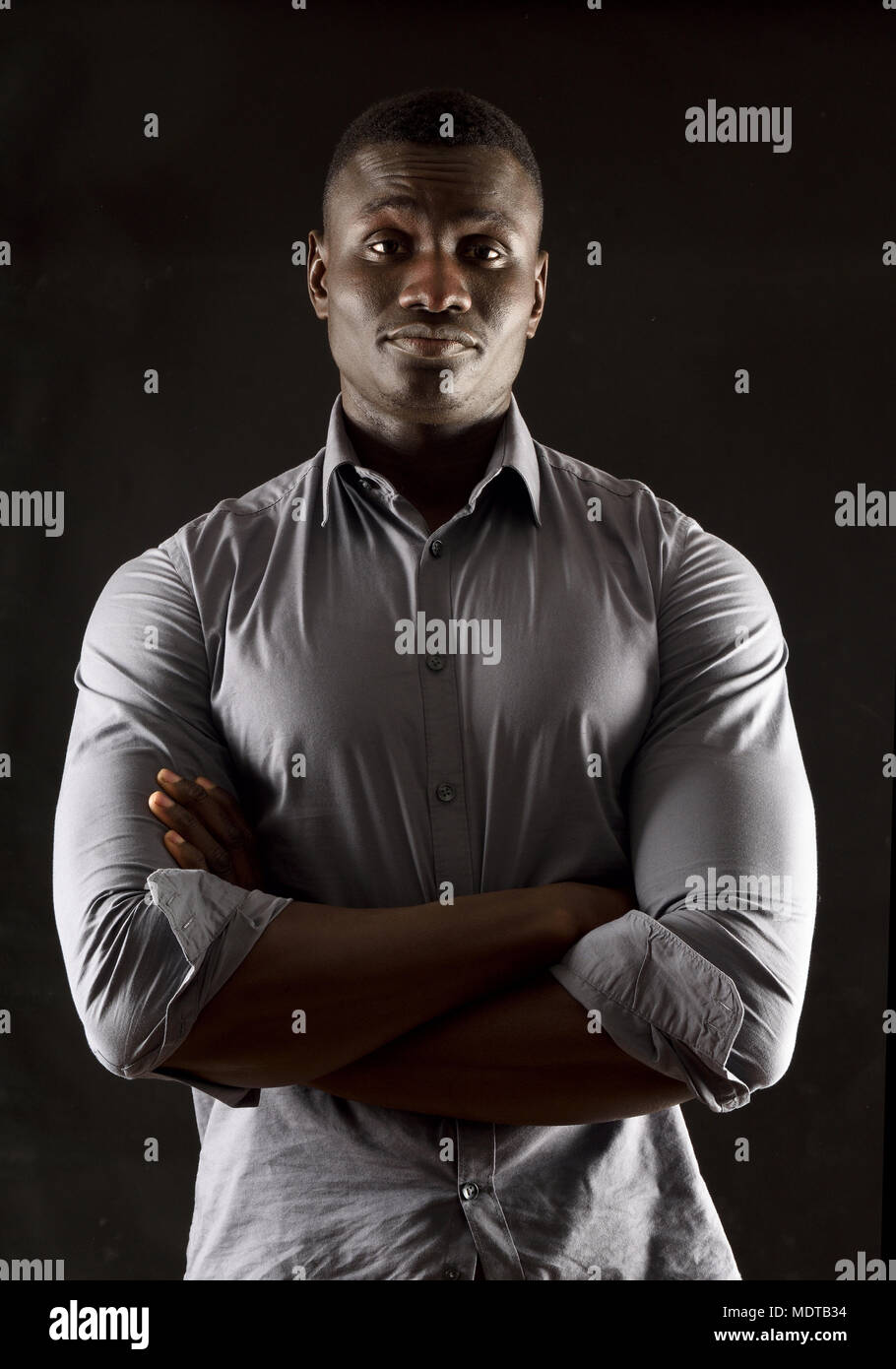 portrait of a african man arms crossed Stock Photo - Alamy