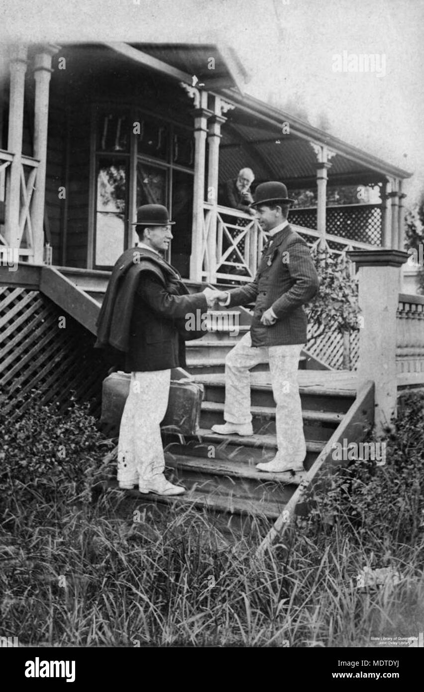 Two men shakes hands, standing on the steps of a Stock Photo - Alamy