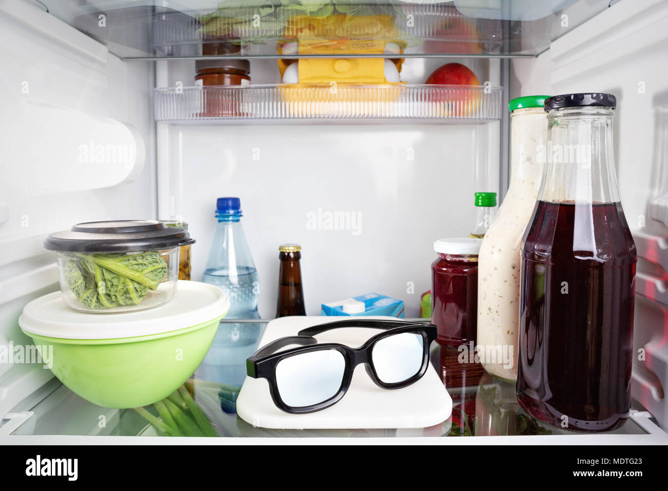 Eyeglasses misplaced in a fridge Stock Photo