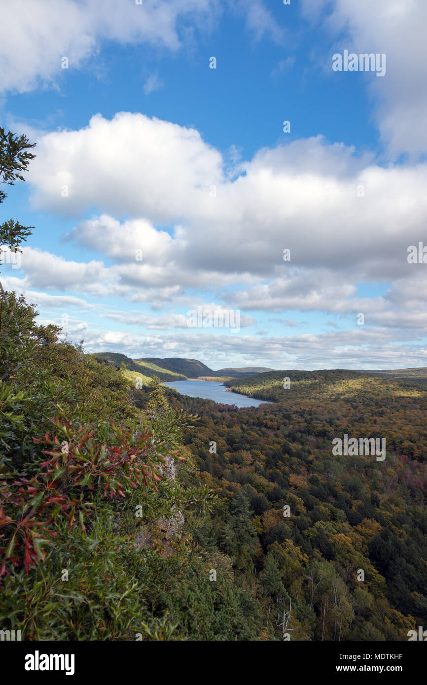A blue sky with white puffy clouds set the scene as the Big Carp River wends its way towards Lake of the Clouds at Porcupine Mountains, in the U.P. Stock Photo