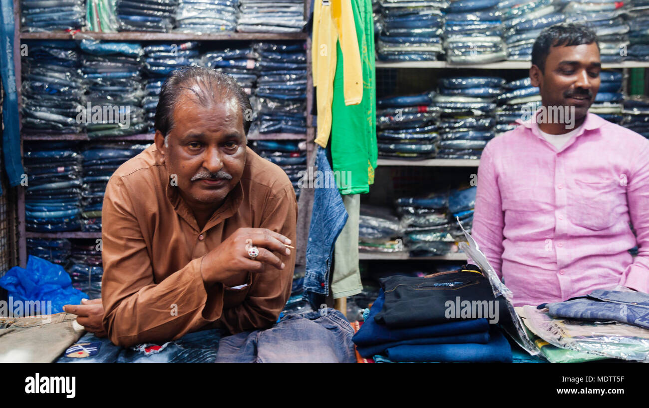 It's been a long day for this businessman at his jeans shop Stock Photo -  Alamy