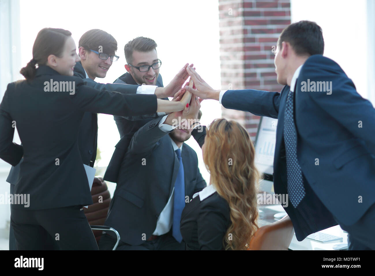 business team giving each other high five Stock Photo - Alamy