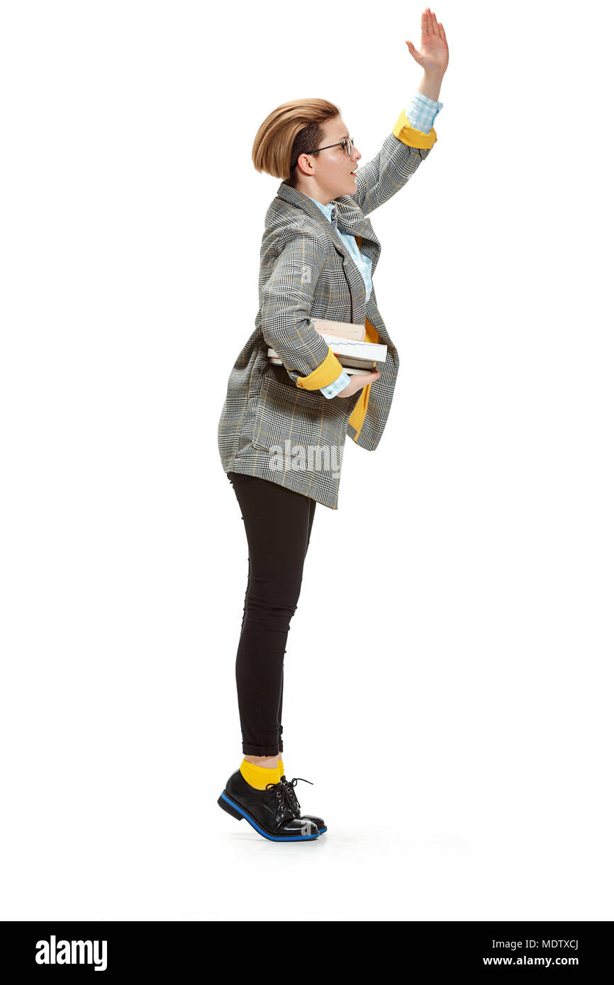 Full length portrait of a happy smiling female student holding books ...