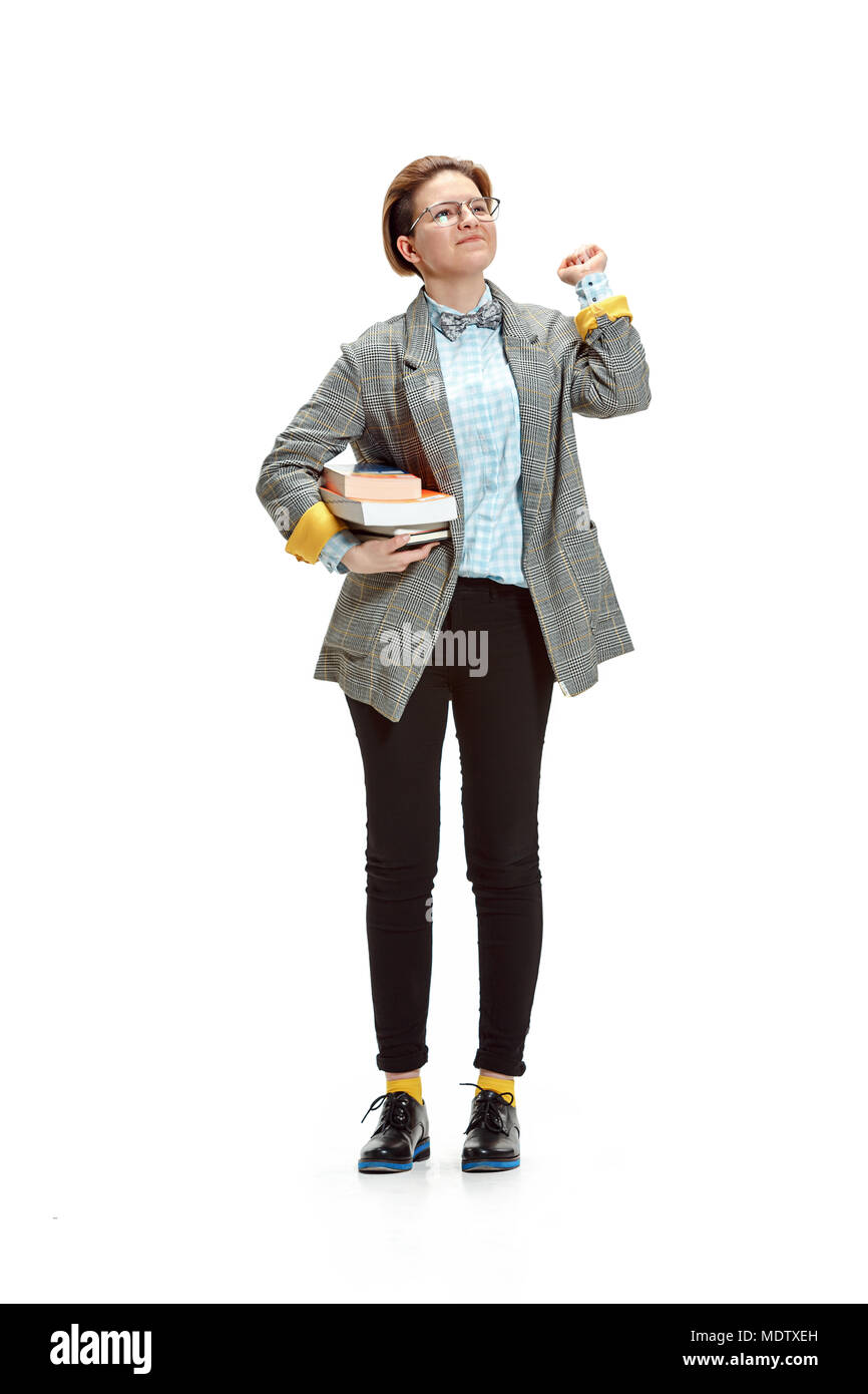 Full length portrait of a happy smiling female student holding books ...